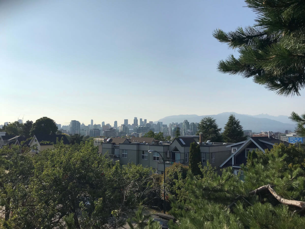 The view from my 3rd-floor balcony. Downtown Vancouver and the north shore mountains can be seen on a beautifully sunny and clear day.